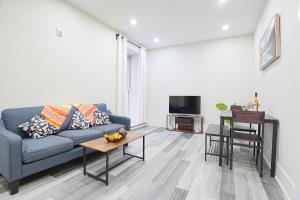 a living room with a blue couch and a table at Cozy stays in Montreal