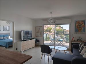 a living room with a couch and a tv at Beautiful Sea View Home Overlooking Monaco in Beausoleil