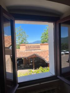 a window view of a restaurant with a sign on it at Casa Bellini in Gallinaro
