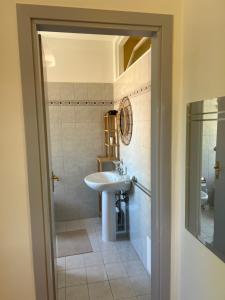 a bathroom with a sink and a mirror at Casa Bellini in Gallinaro +9 photos