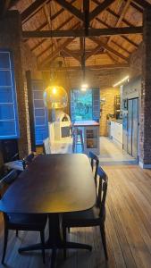 a kitchen and dining room with a table and chairs at Casa 80 in Monte Belo