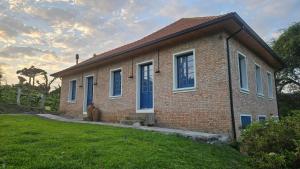a brick house with a teddy bear in front of it at Casa 80 in Monte Belo