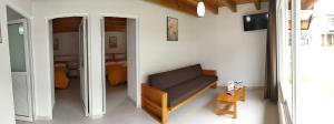 a living room with a couch and a mirror at Hotel Ensueño del Bosque Valle de Bravo in Valle de Bravo