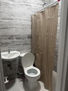 a bathroom with a toilet and a sink at Hotel Azulado - Como el mar in Jamundí +5 photos