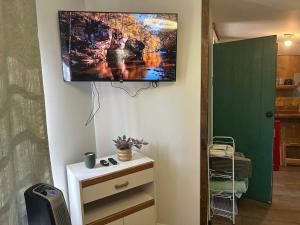 a television hanging on a wall in a room at Swift Hollow Timeless Memories in Mountain City
