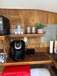 a microwave sitting on a wooden table next to a counter at Swift Hollow Timeless Memories in Mountain City