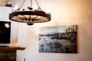 a chandelier hanging on a wall with a picture at Bed-N-Bliss in Kings Beach