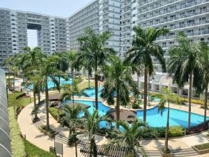 an aerial view of a resort pool with palm trees at Estor Staycation in Manila
