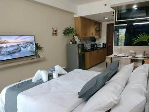 a large white bed in a room with a kitchen at Estor Staycation in Manila