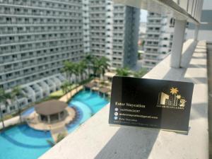 a sign on a balcony with a view of a building at Estor Staycation in Manila