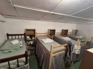 a room with three bunk beds in a room at Hostel Espaço Mulher in Florianópolis