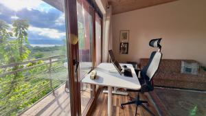 an office with a desk and a computer on a balcony at Prespa Lakeview Villa in Resen