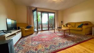 a living room with a tv and a couch and a table at Prespa Lakeview Villa in Resen
