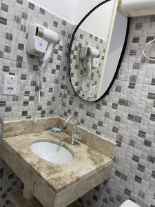 a bathroom with a sink and a mirror at Pousada Imperial in Seabra +33 photos