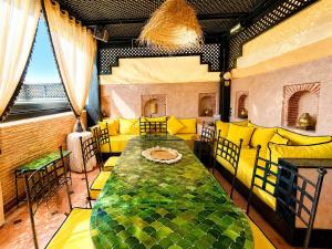 a room with a large bed with yellow pillows at Riad Dar Najwa in Marrakesh