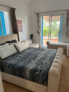 a large bed in a room with a couch and a bedzinski at Smirpark appartement in M'diq +15 photos