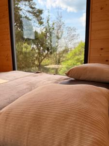 a bedroom with a bed and a window with a view at Maringotka na kopečku in Kotaneč +7 photos