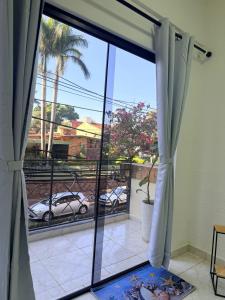 a room with a large window with a view of a parking lot at GuestHouse Encanto del Centro 4 in Encarnación