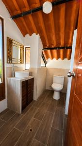 a bathroom with a toilet and a sink at Mi Shalita in Santa Cruz