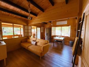a living room with a couch and a table at Ohana Gerês House in Ruivãis