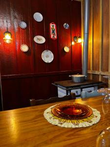 a dining room with a table and plates on the wall at Casa Centenária com 20 min de Gramado in Três Coroas +5 photos