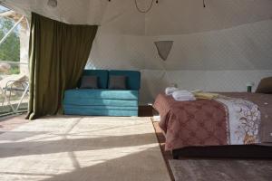 a room with a bed and a couch in a tent at Glamping Krupac Lake in Blaca +22 photos