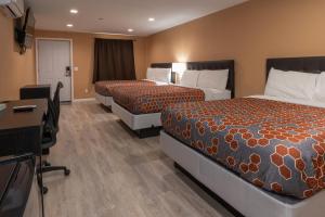 a hotel room with two beds and a desk at Far West Cabin-Tiny Homes Rental in Forks