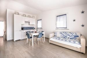 a living room with a couch and a table at Costa Paradiso Sea View - 8 Guests in Trinità d'Agultu e Vignola +25 photos