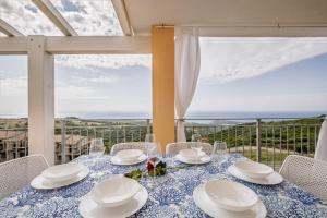 a dining table with a view of the ocean at Costa Paradiso Sea View - 8 Guests in Trinità d'Agultu e Vignola