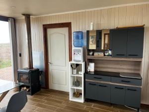 a kitchen with a stove and a counter top at Casa del Sol in Cobquecura +5 photos