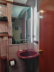 a bathroom with a red sink and a mirror at Cusco Tahuanwasi Apartments in Cusco +39 photos