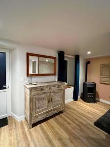 a room with a wooden dresser and a mirror at Cozy studio in Millières