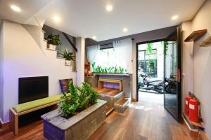 a living room with a couch and a fireplace at Harmony Stay - Ben Thanh Market in Ho Chi Minh City
