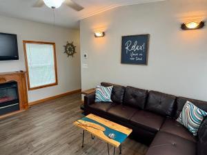 a living room with a couch and a table at Mississippi River Cabin in Bellevue
