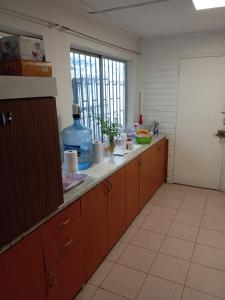 a kitchen with wooden cabinets and a counter top at Casa in Santiago