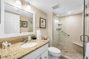 a bathroom with a sink and a toilet and a shower at Waterfront Island Oasis! Heated Pool with Stunning View & 2 Full Bath in Marco Island +18 photos