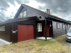 a small house with a red garage at Sirdal in Dirdal