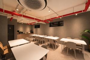 a room with white tables and chairs and a kitchen at OstelloMaree 오스텔로마레 Tax Benefit in Seoul