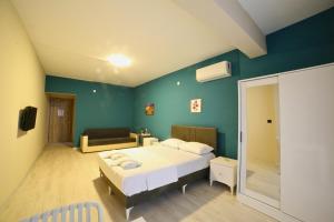 a bedroom with a white bed and a blue wall at Lemon Garden in Antalya
