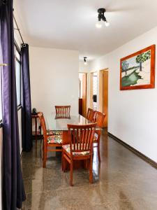 a dining room with a table and chairs at Residencial Alice in Uberaba