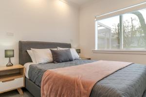 a bedroom with a bed and a window at 19 Broadway in Martinborough