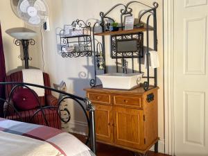 a bathroom with a sink on a wooden dresser at La maison du petit rang in Saint-Éloi