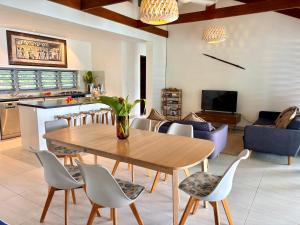 a living room with a wooden table and chairs at The Namele Villas in Port Vila