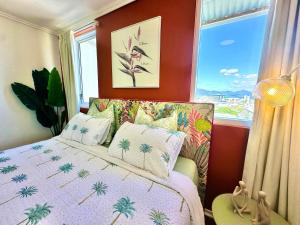 a bedroom with a bed and a large window at Prime CBD High Rise Apartment in Cairns +13 photos