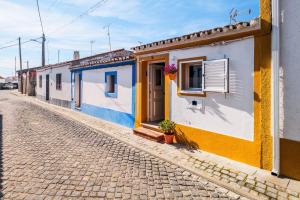 a row of houses on a cobblestone street at Descanso Alentejano -Casa d'aldeia in Campinho