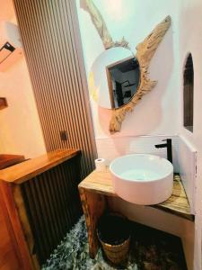 a bathroom with a sink and a mirror on the wall at Sand 1 Hostel in Siquijor +57 photos