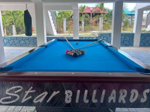 a pool table with two cues on top of it at U Cube Staycation in Manaoag