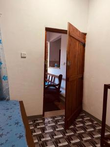 a door leading into a room with a bedroom at KR Villa in Arugam Bay +1 photo