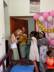 a group of women standing in a room with balloons at KR Villa in Arugam Bay