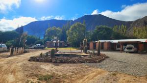a parking lot with a house and mountains in the background at Al Pie del Pucara in Tilcara
